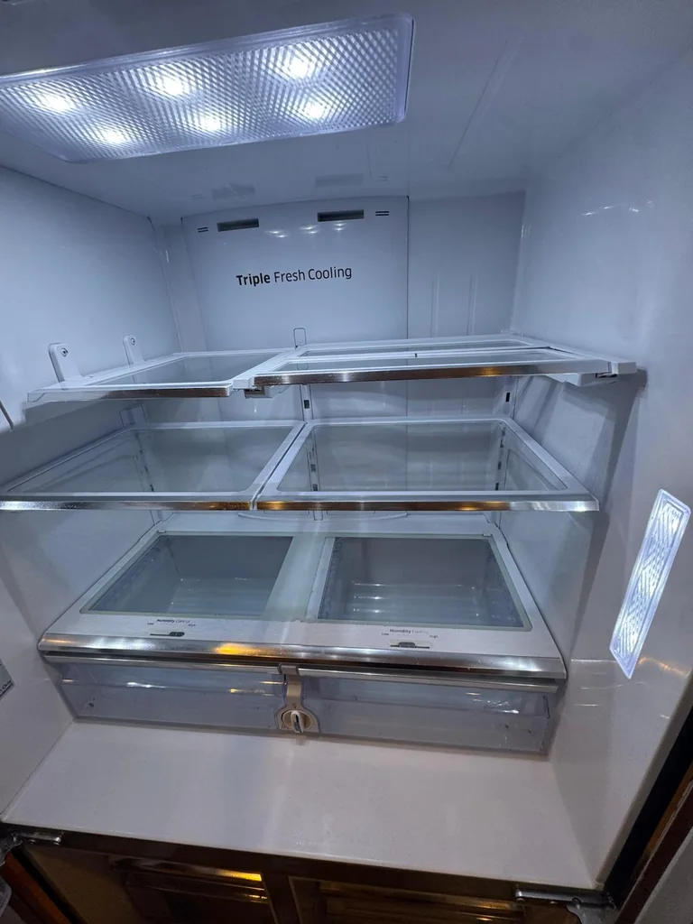 Refrigerator after deep cleaning, shelves clear and spotless